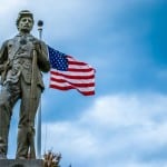 koster-Statue-with-flag